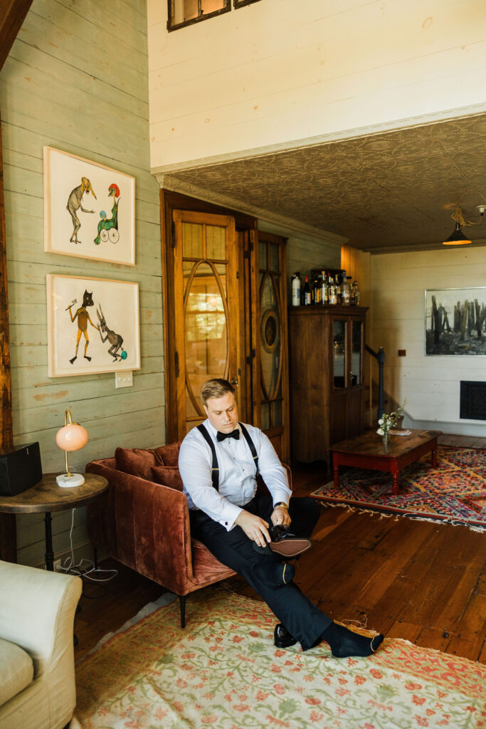 Groom getting ready before Brecknock Hall wedding