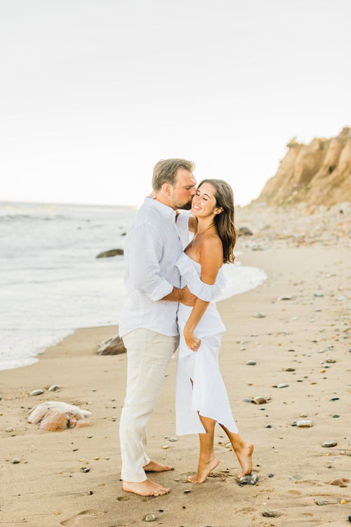 Couple posing on the beach for Long Island wedding photographer.